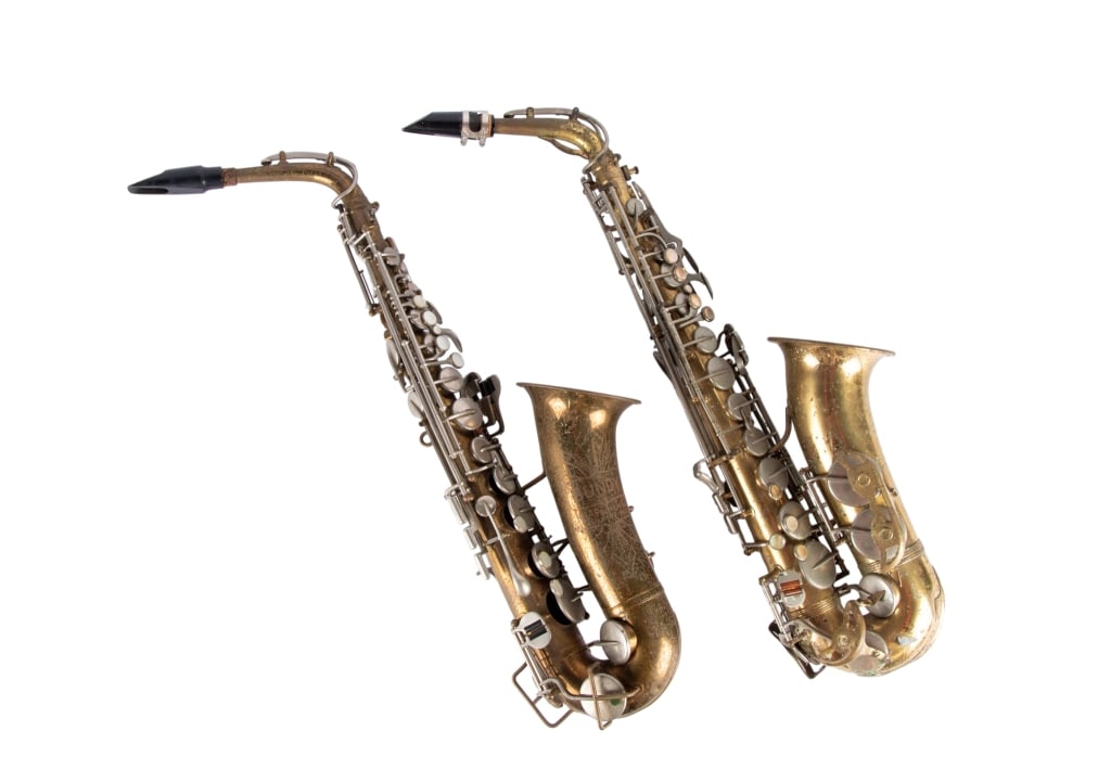 TWO VINTAGE BRASS SAXOPHONES: Two vintage brass saxophones, one Parisian Ambassador F.E. Olds & Son and one Bundy, comes with case. Approximate dimensions: h. 27", w. 5", d. 8" Disclaimer: Participating bidders must have a credit