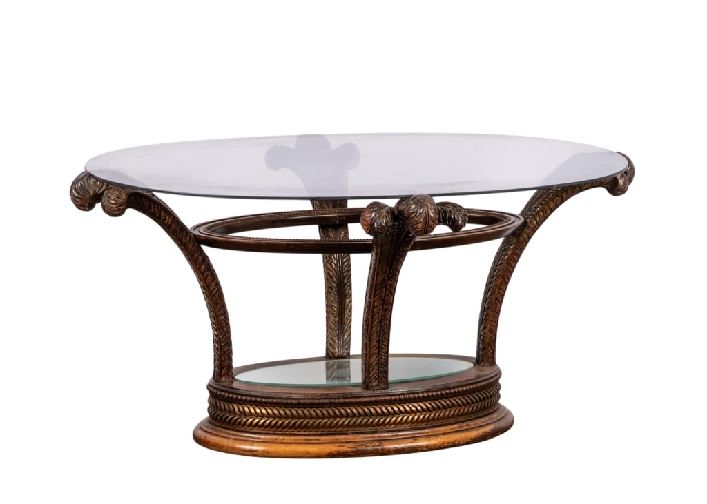 HOLLYWOOD REGENCY SMOKED GLASS TOP COFFEE TABLE: Hollywood Regency smoked glass top coffee table with carved supports and mirrored accent. Approximate dimensions: h. 19", w. 39", d. 20" Disclaimer: Participating bidders must have a credit card on