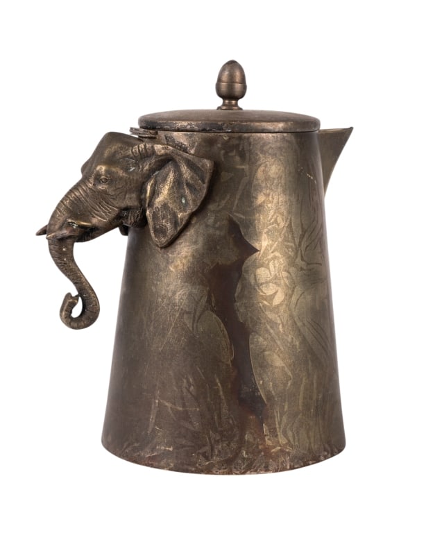 FIGURAL ELEPHANT MOTIF PITCHER: Figural elephant motif pitcher. Approximate dimensions: h. 9.5", w. 8", d. 6" Disclaimer: Participating bidders must have a credit card on file with LiveAuctioneers in order for their bidding