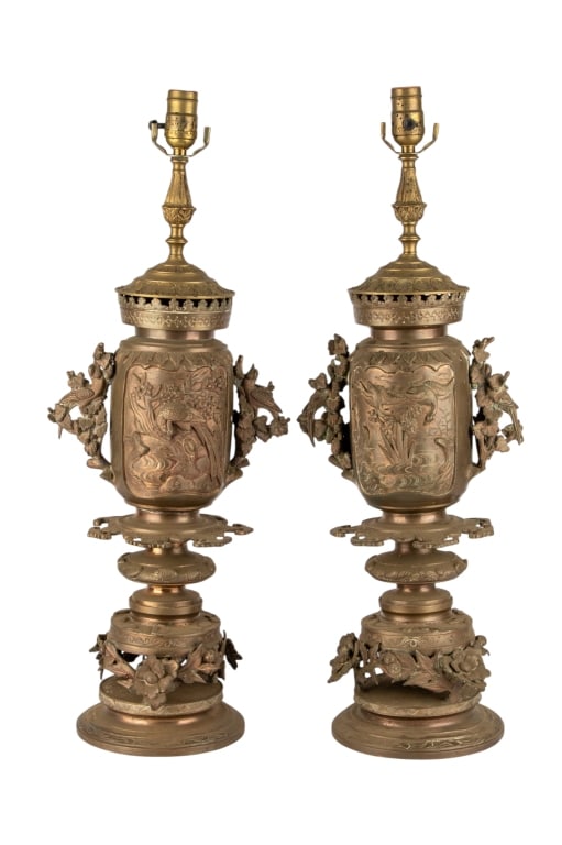 PAIR OF ASIAN BRASS TABLE LAMPS: Pair of Asian brass table lamps with floral and bird motif. Approximate dimensions: h. 27", w. 9", d. 8" Disclaimer: Participating bidders must have a credit card on file with LiveAuctioneers in