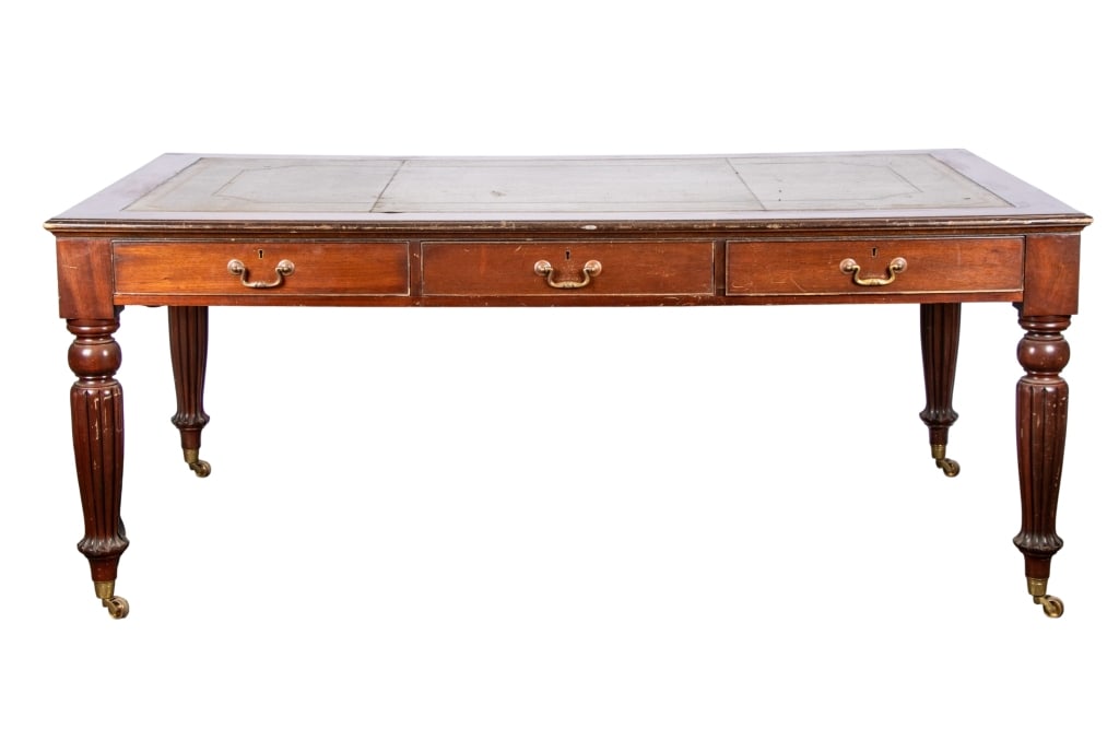 GEORGE III STYLE LEATHER TOP WRITING DESK: George III style leather top writing desk with turned castered legs, green leather top, six drawers. Approximate dimensions: h. 30", w. 73.5", d. 43.5" Disclaimer: Participating bidders must have a