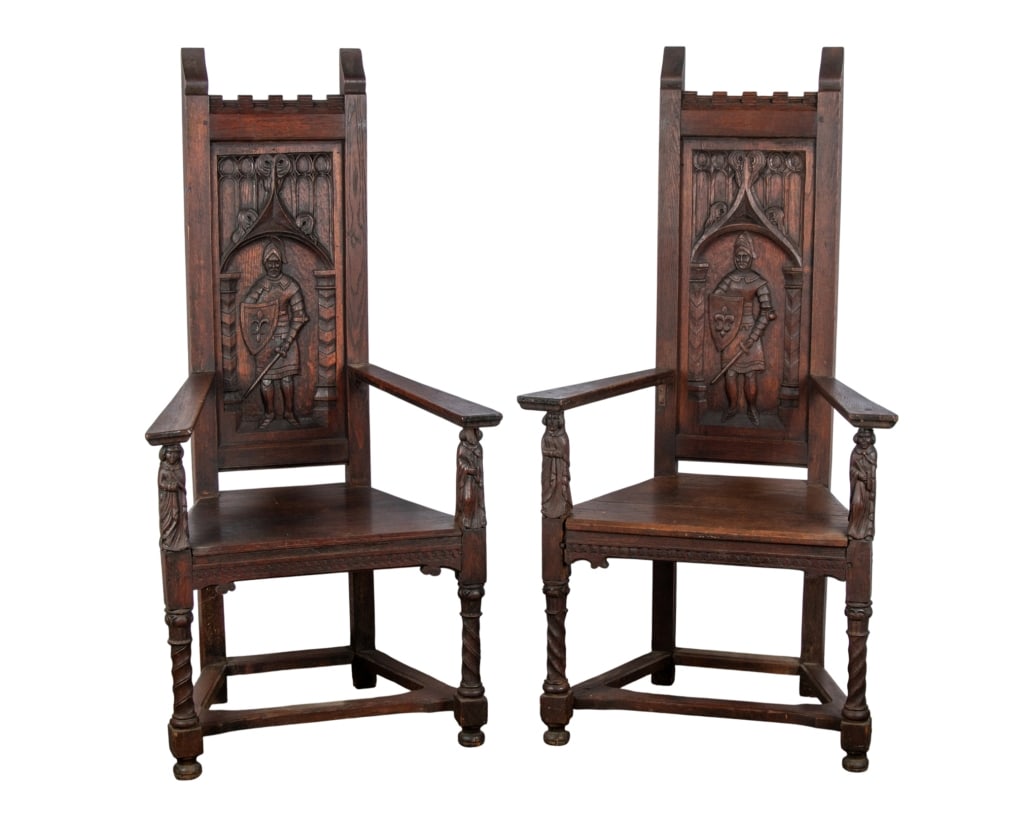 PAIR OF RENAISSANCE REVIVAL CARVED ARMCHAIRS: Pair of Renaissance Revival carved armchairs with figural inset carved panels, stretcher base, figural carved arm supports, and bun feet. Approximate dimensions: h. 55", w. 29", d. 21" Disclaimer: