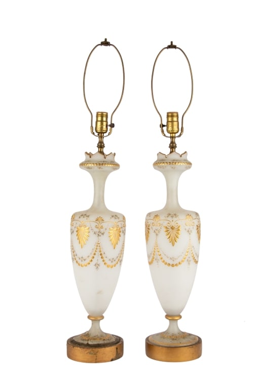 PAIR OF FROSTED GLASS TABLE LAMPS: Pair of frosted glass table lamps with painted gold accents. Approximate dimensions: h. 34", w. 5.5", d. 5.5" Disclaimer: Participating bidders must have a credit card on file with LiveAuctioneers in