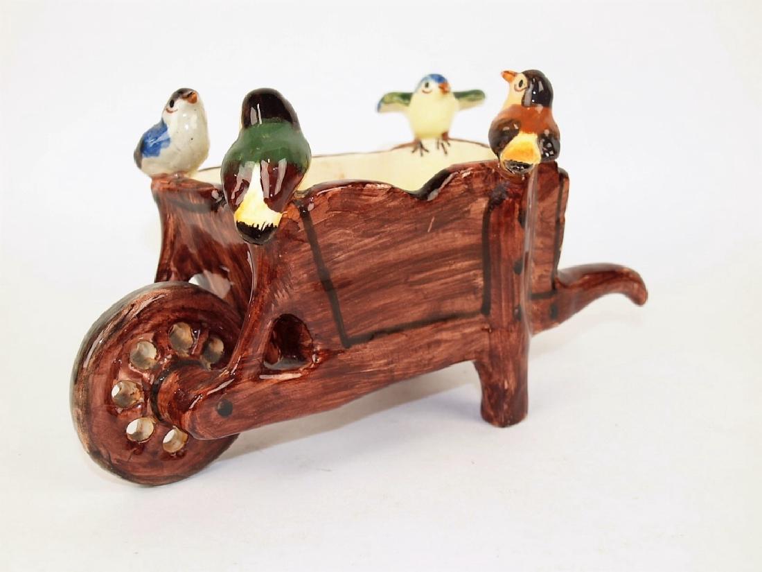 Massier Majolica wheelbarrow planter with 4 birds: Massier Majolica wheelbarrow planter with 4 birds perched on rim, 9 1/2" l perched on rim, 9 1/2" l