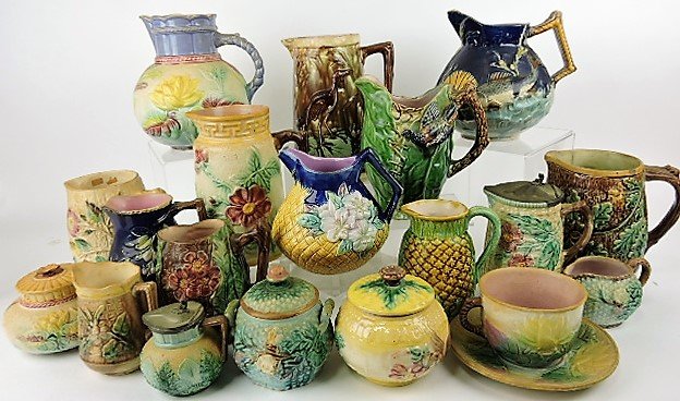 Majolica lot of 19 pitchers, sugars, and: cup/saucer, various conditions