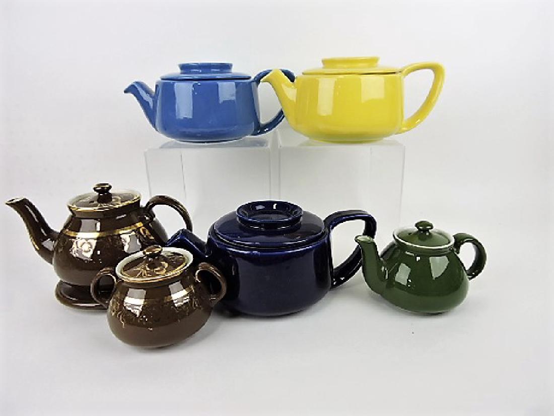 Hall China lot of 5 teapots, one with sugar and: trivet