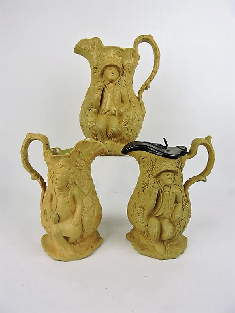 "Toby Filpot" set of 3 brown molded jugs, 11", 9",: 9" with pewter top (hairline)