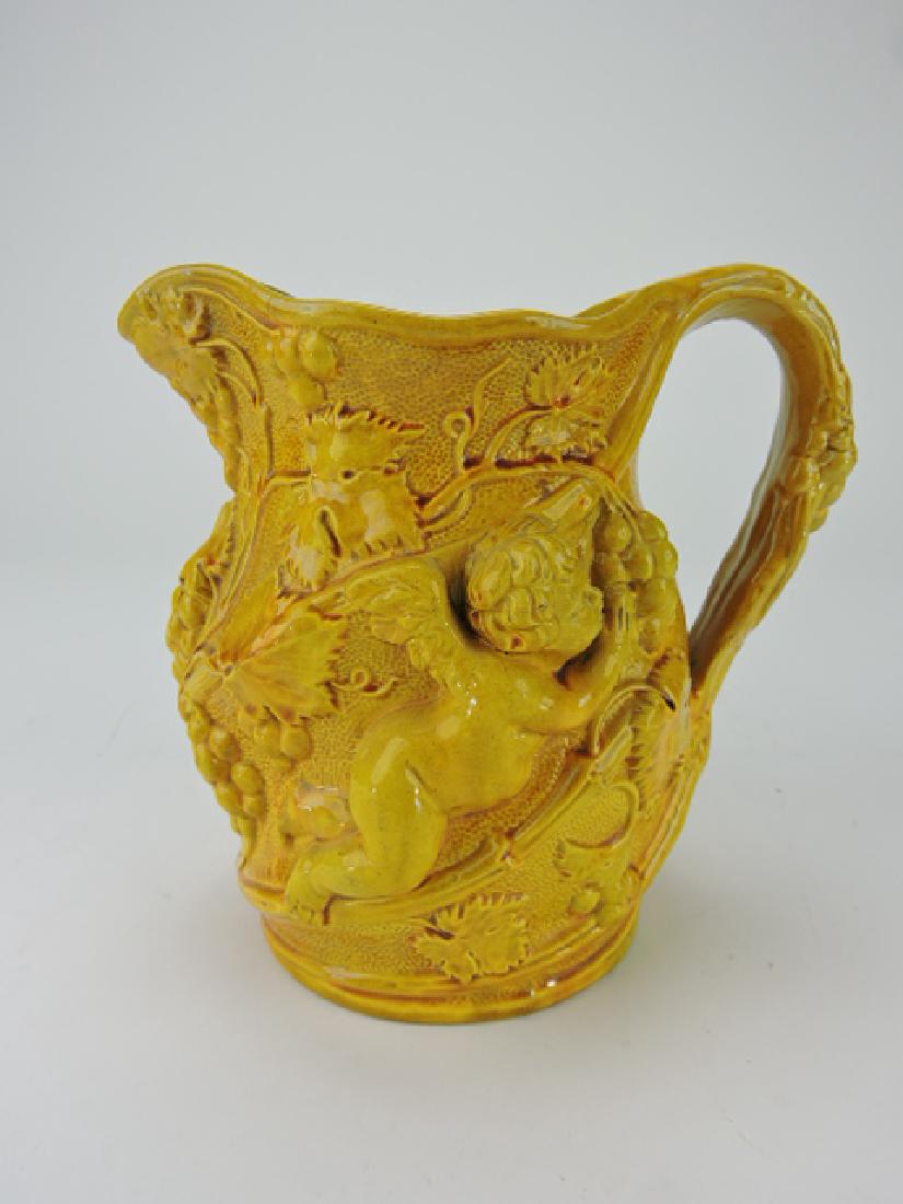 Minton yellow majolica cherubs wine jug, 7": .