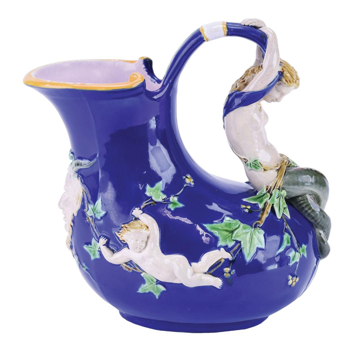 Minton Majolica "Askos"™ Mermaid Wine Pitcher.: c.1875, Classical Greco-Roman form, glazed in cobalt blue, mermaid handle flanked by putti holding ivy garland united with a horned and bearded mask to the front. Shape No. 1420"™, 8". Dawes p. 72, 