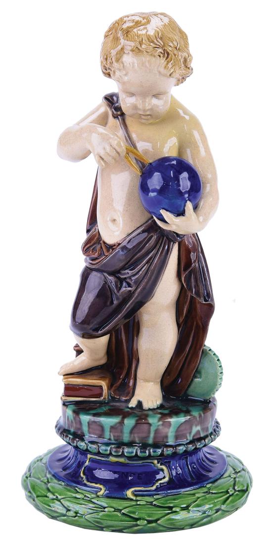 Minton Majolica Figure "Science"™ c.1875 Designed: by Albert Carrier Belouse. Shape no. 367. Modelled as a draped putto holding a gold and dividers and stood in front of a pile of books and large cog, the circular pedestal base decorated with laurel a