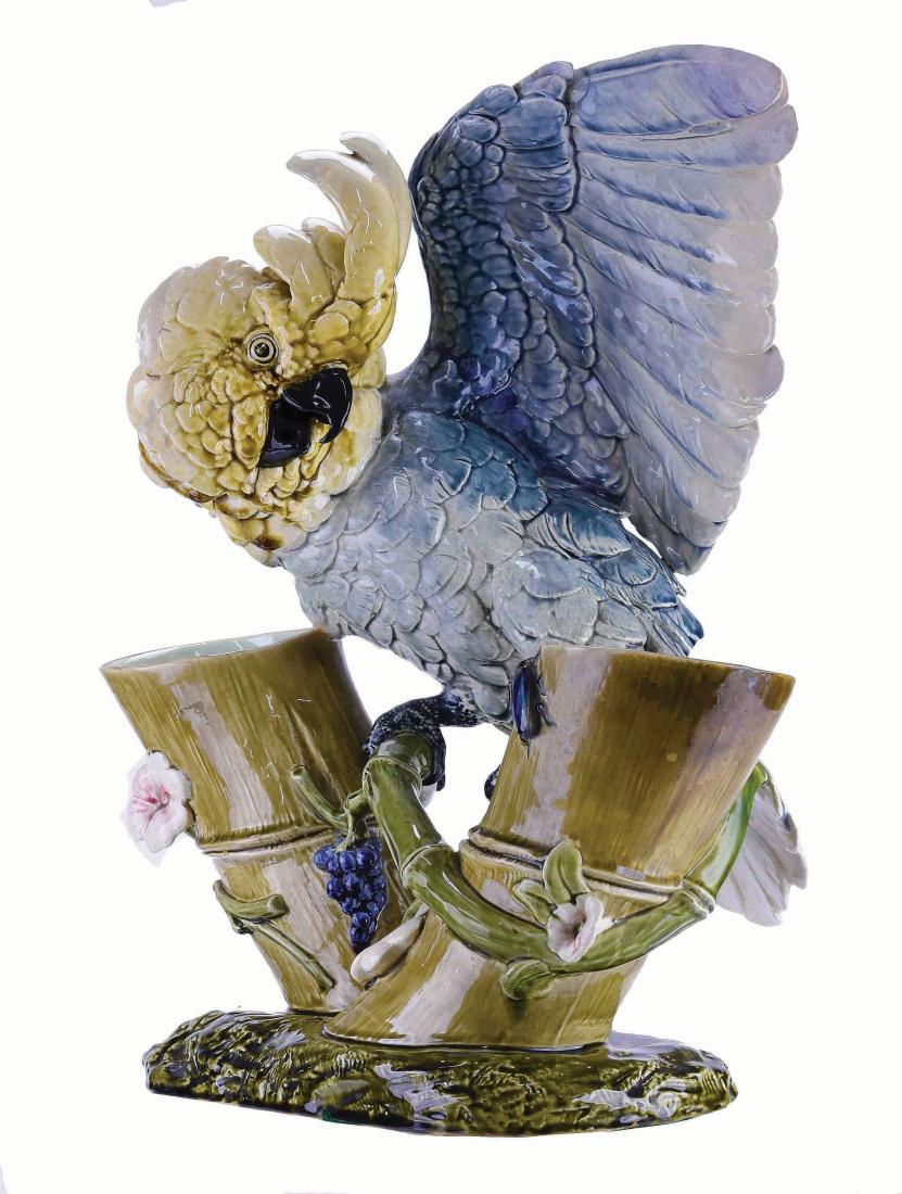 A Striking Life Size Choisy Le Roi Majolica: Cockatoo Vase c.1875 Designed by Paul Comolera, c.1875, modeled as a grey and golden open winged cockatoo perched between two bamboo canes forming the flower holders, all upon an oval olive green, ear