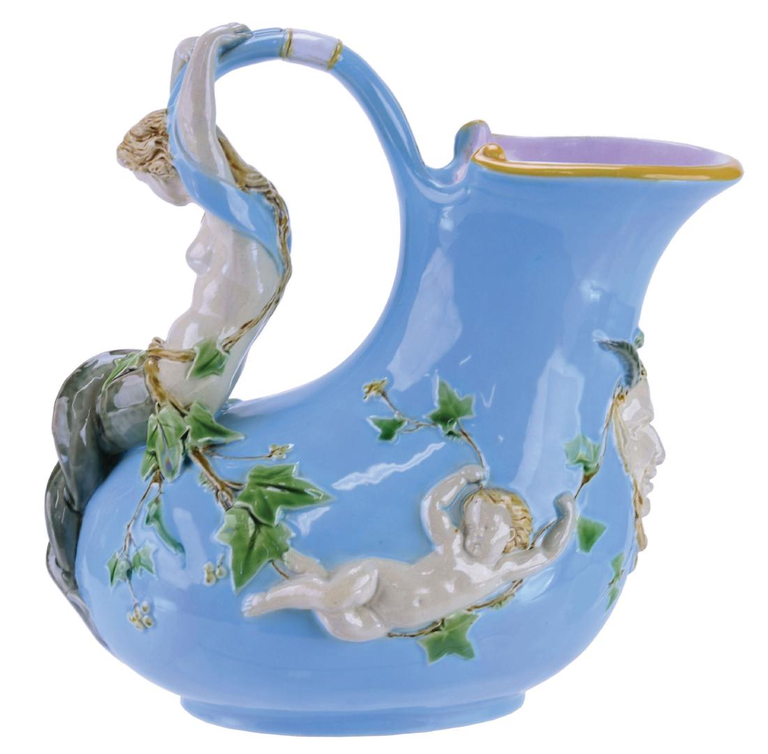 Minton Majolica "Askos"™ Mermaid Wine Pitcher: c.1875, Classical Greco-Roman form, turquoise body, mermaid handle flanked by putti holding ivy garland united with a horned and bearded mask to the front. Shape No. 1420"™, 8"h, 8"w. Dawes p. 72, J