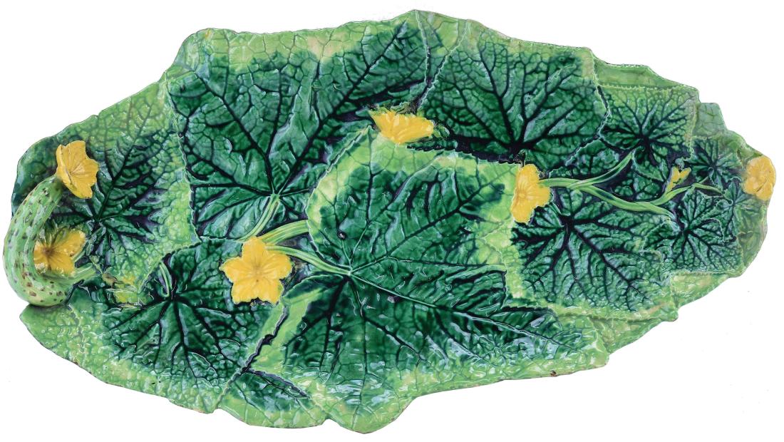 George Jones Majolica Cucumber Sandwich Tray: c.1875, modeled as a long oval tray of cucumber leaves and yellow blossoms, an attached small cucumber and yellow blossom to one end, 16 1/2". Curated and catalogued by Nicolaus Boston