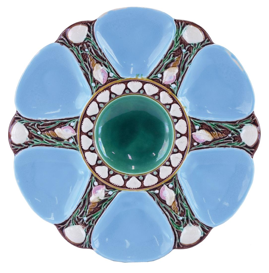 Minton Majolica Six Well Turquoise Oyster Plate: c.1875 modeled as a circular plate with turquoise wells separated by shells and seaweed, the green circular central well surrounded by conch shells, 9". Donna & David Reis Collection Curated and catal