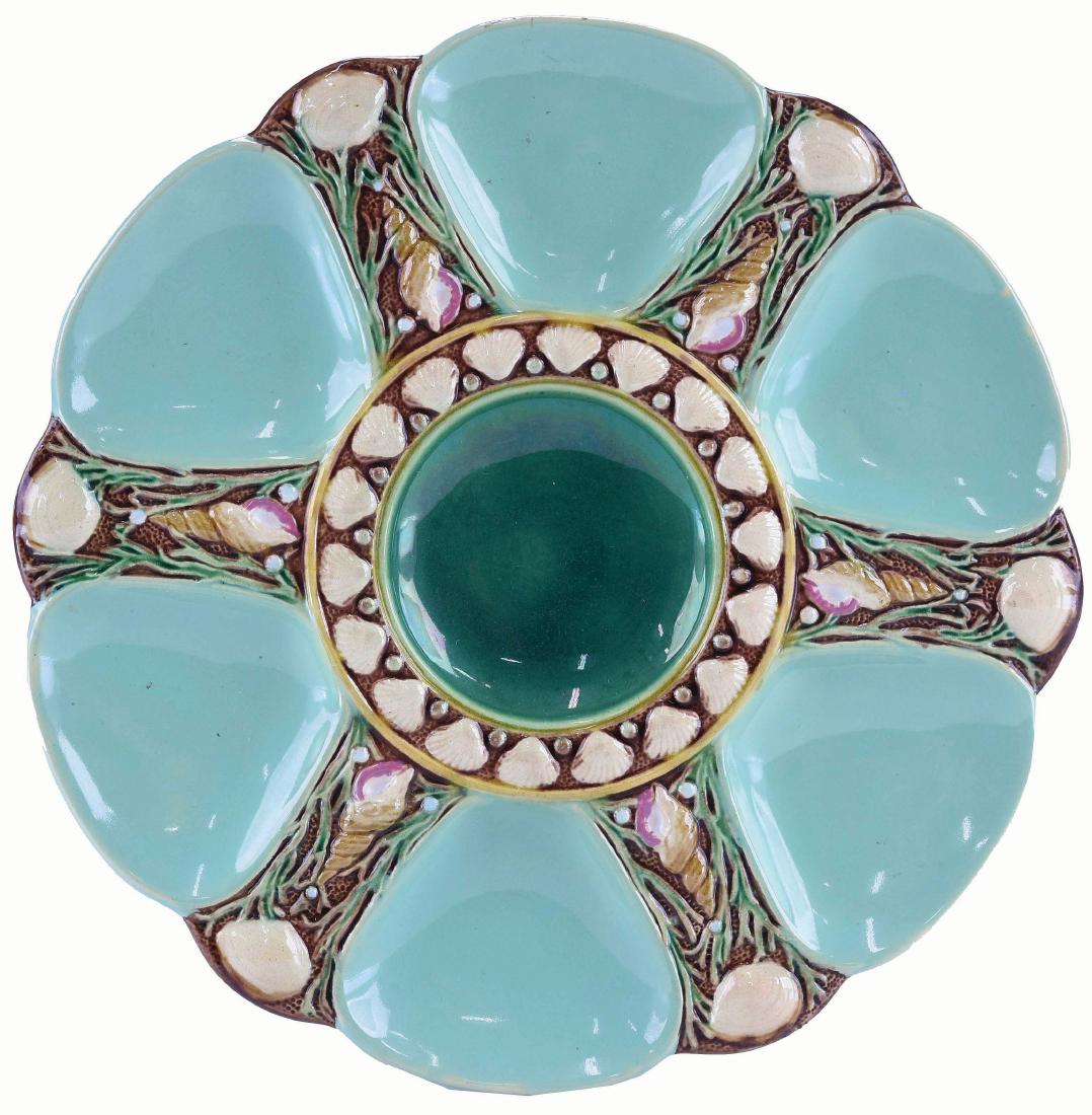 Minton Majolica Six Well Celadon Oyster Plate: c.1875 modeled as a circular plate with celadon wells separated by shells and seaweed, the green circular central well surrounded by conch shells, 9". Curated and catalogued by Nicolaus Boston