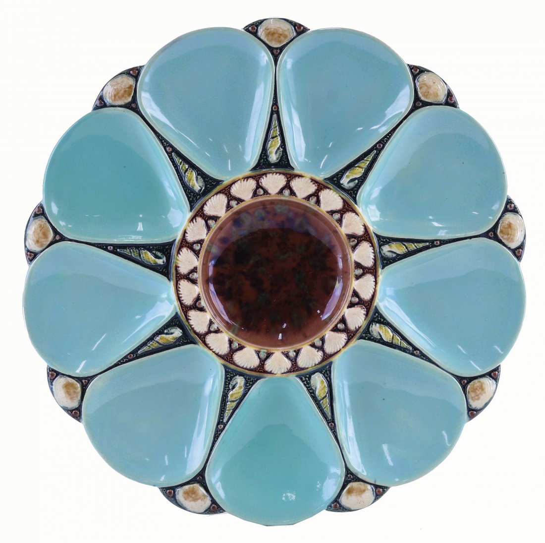 Minton Majolica Nine Well Celadon Oyster Plate: c.1875 modeled as a circular plate with celadon wells separated by shells, the brown circular central well surrounded by conch shells, 9". Curated and catalogued by Nicolaus Boston