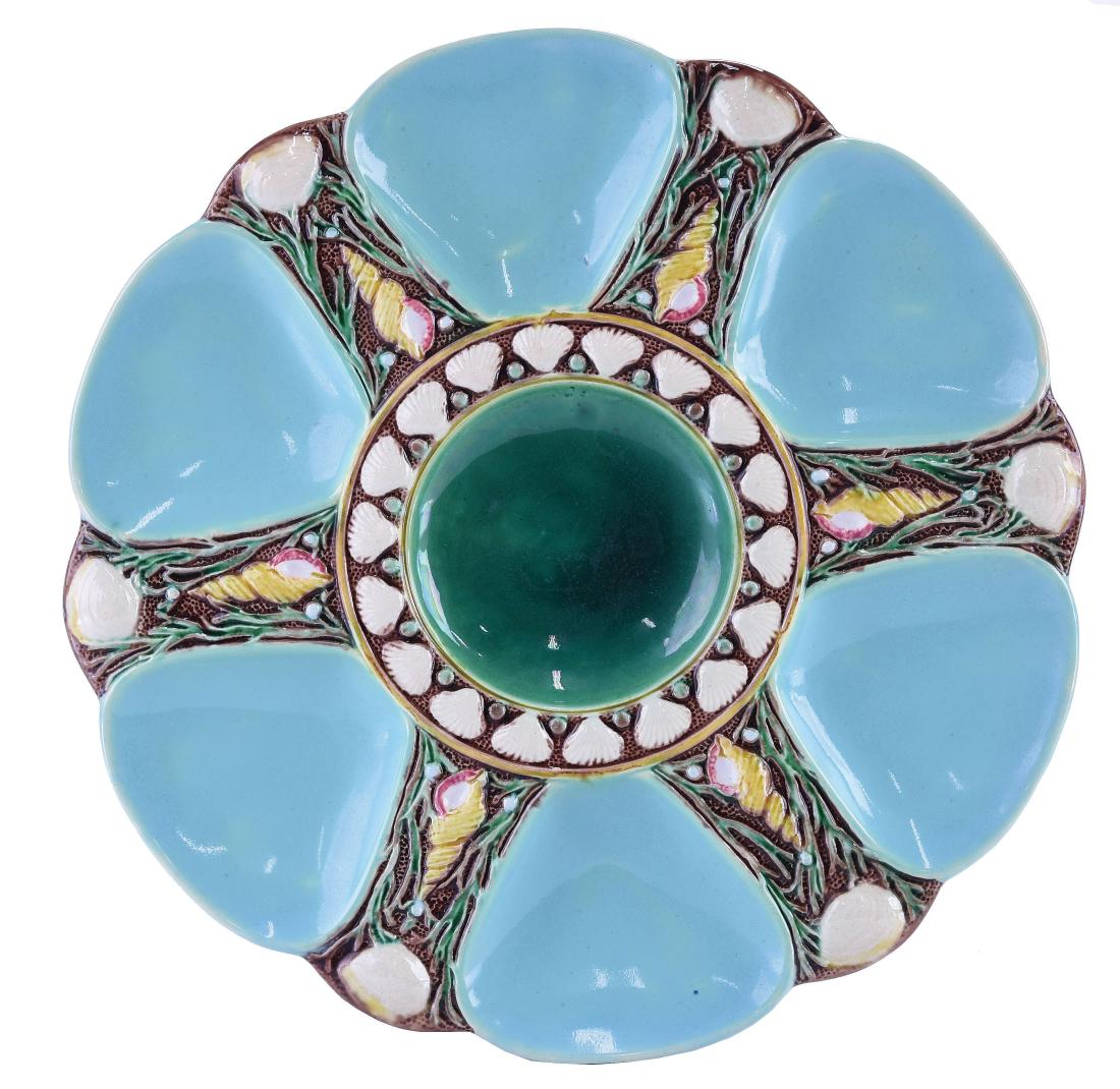 Minton Majolica Six Well Celadon Oyster Plate: c.1875 modeled as a circular plate with celadon wells separated by shells and seaweed, the green circular central well surrounded by conch shells, 9". Curated and catalogued by Nicolaus Boston