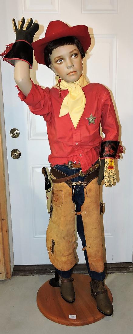 Daisy Red Ryder boy mannequin: dressed in Red Ryder outfit with hat, gloves, sherriff badge, gun, holster, chaps, Lee jeans, cowboy boots and spurs, 59"