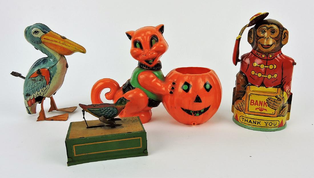 Vintage toy lot of 4; J Chein tin: lithograph Pelican wind up; J Chein tin lithograph monkey bank; German tin lithograph wind up bird; and hard plastic cat with jack-o-lantern