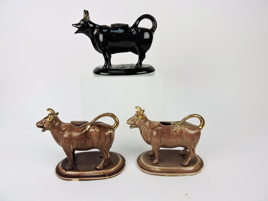 Brown and black glaze lot of 3 cow: creamers, 2 with lids, various condition