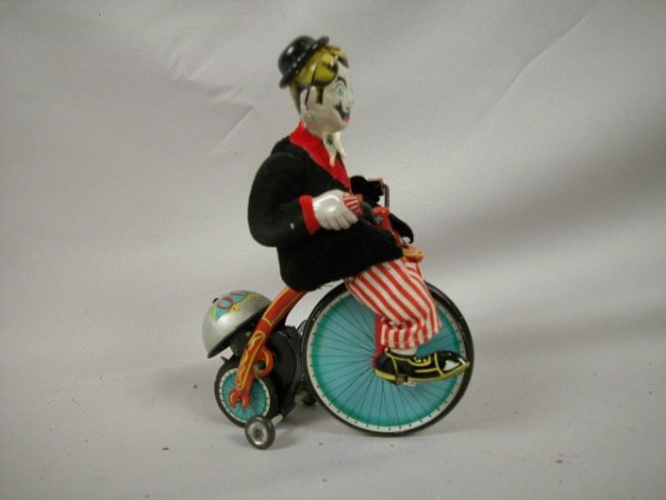 Early T.P.S. Japan tin windup clown on bicycle, 6