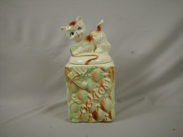 American Bisque cat with yarn atop tufted jar coo: American Bisque cat with yarn atop tufted jar cookie jar, interior rim chip to base