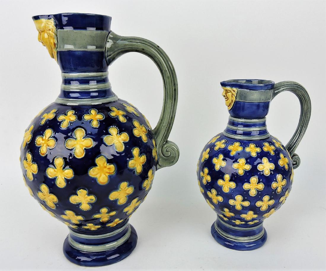 Minton majolica pair of cobalt jugs: with face spouts, 11" & 8 1/2"