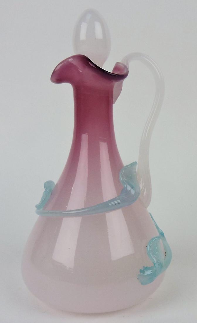 Cranberry opalescent art glass: cruet with applied leaf and vine