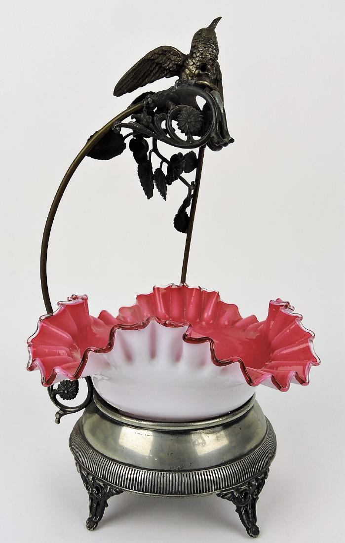 Cranberry cased glass bride's: basket in silver plate holder with bird handle