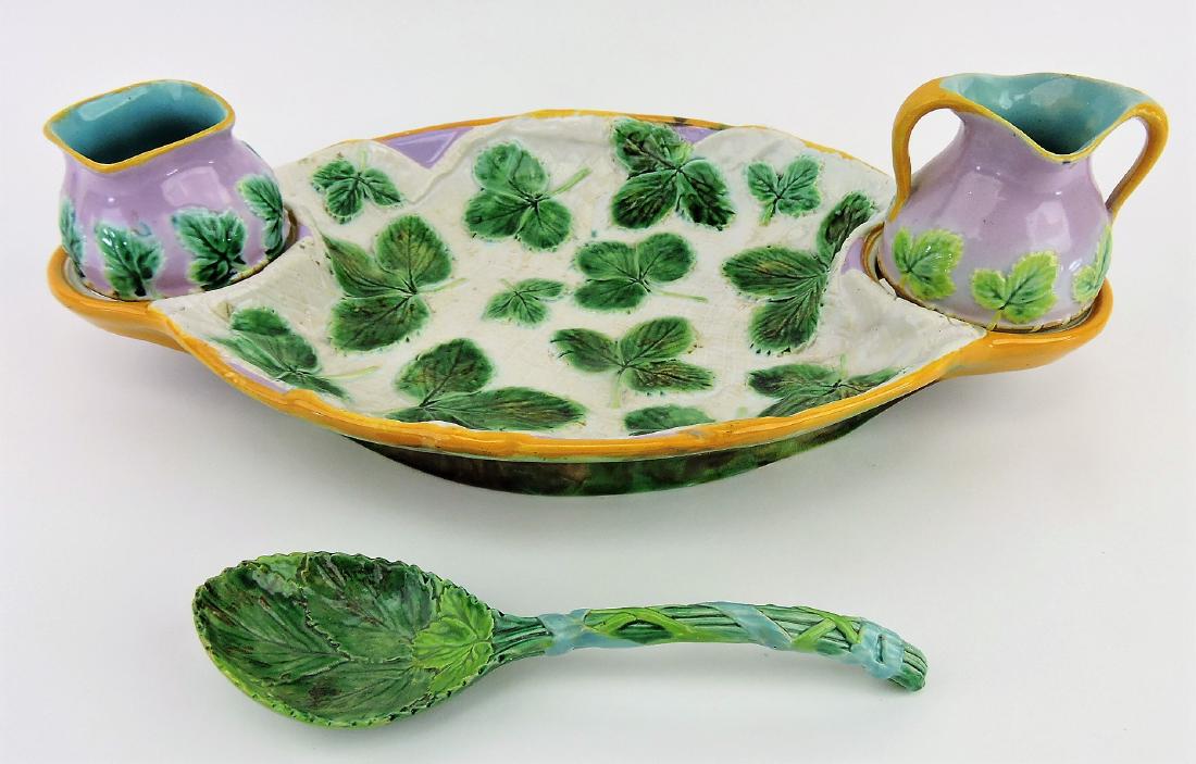 George Jones majolica napkin on: pink ground strawberry server with cream, sugar, and serving spoon