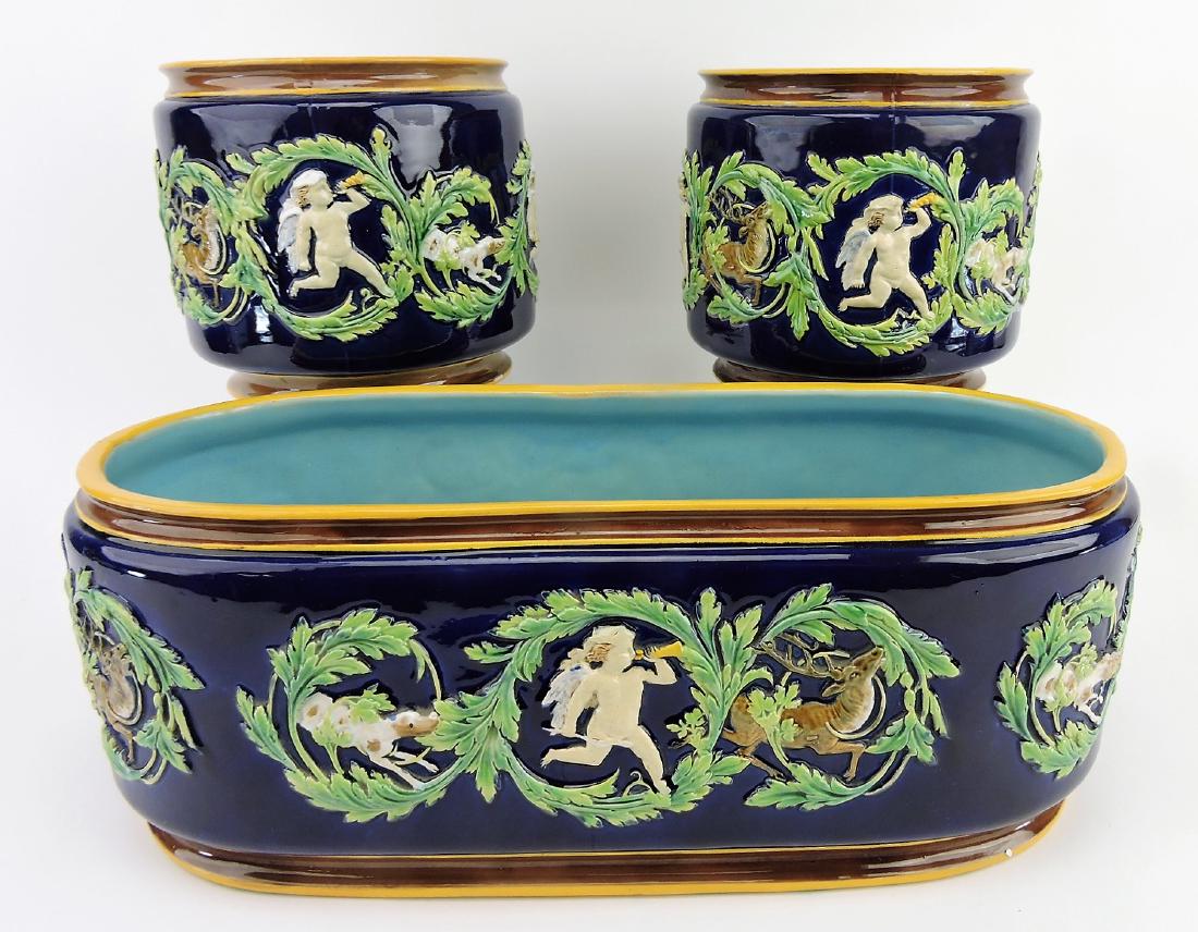 George Jones majolica cobalt: 3 piece jardiniere set with 17" x 6" oval jardiniere and two matching 7" jardinieres, all decorated with hunter, stag, and hunting dog