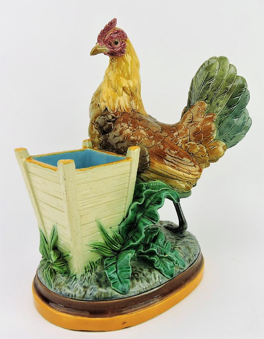 Minton majolica rooster flower vase: designed by John Henk, modeled as a rooster standing beside a wooden plank flower holder on oval base, 13", shape no. 1983, minor nick to leaf edge