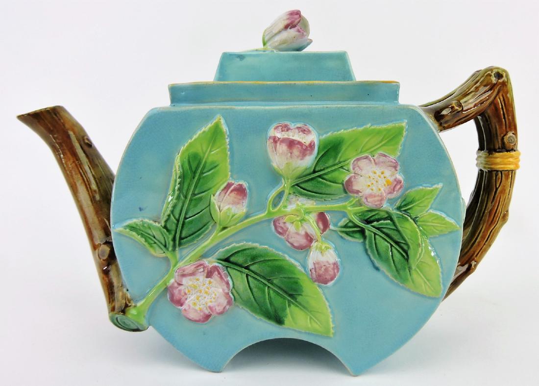 George Jones majolica turquoise: floral teapot with vine handle and spout, flower blossom finial, professional repair to spout and lid rim, 6 1/2"h, 10"w