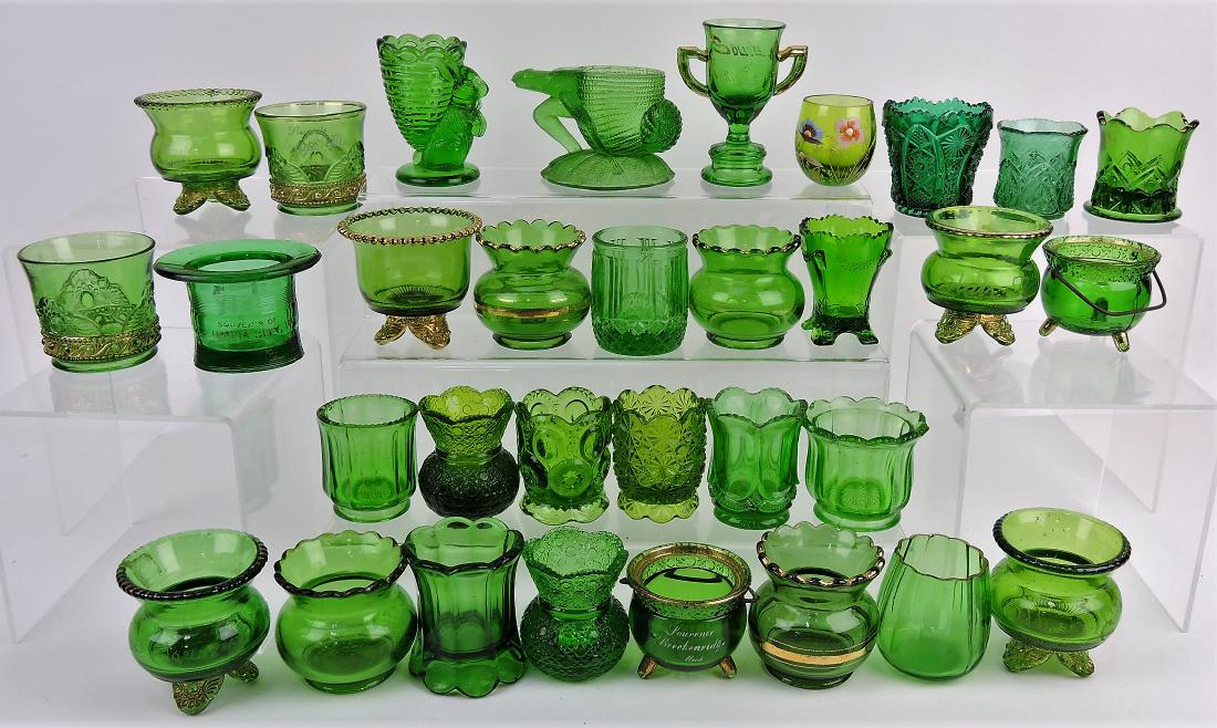 Green glass group of 31 toothpick: holders, including some souvenir