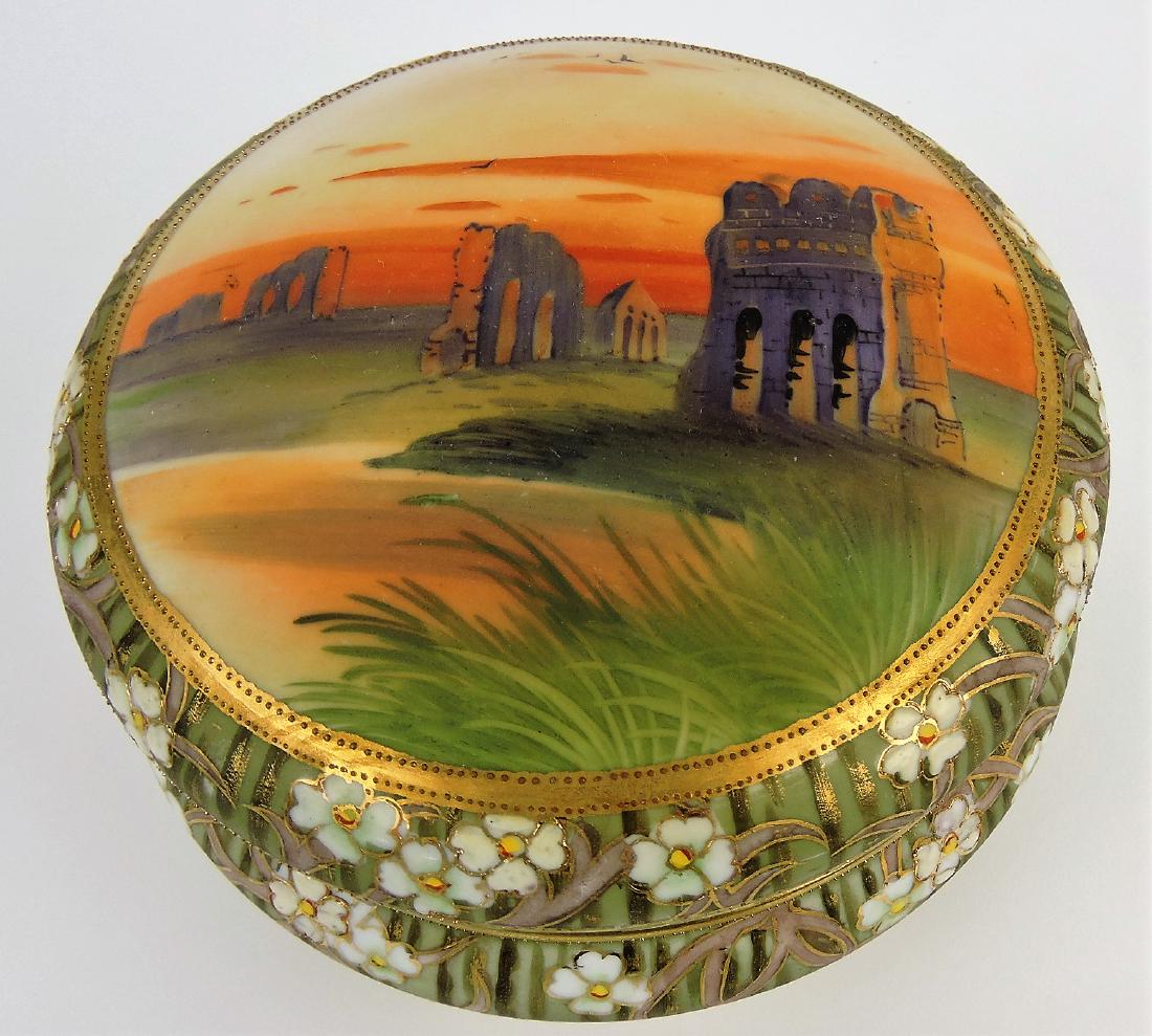 Nippon 7 1/2" covered jar with: scenic cover and floral border