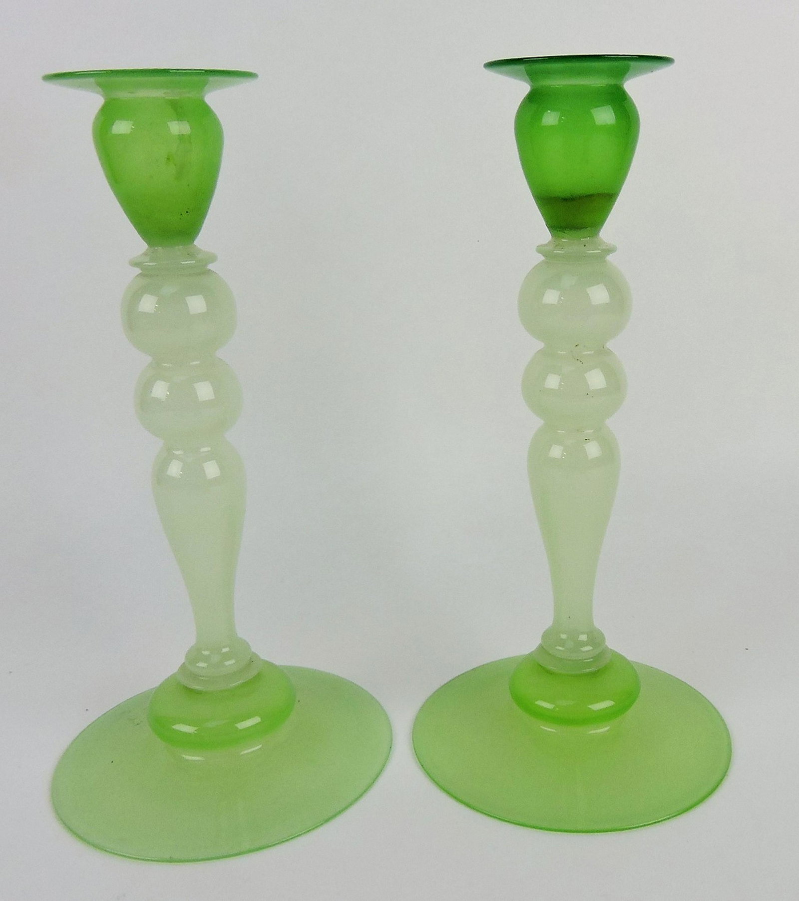 Steuben (attributed) pair of green: alabaster candlesticks, repair to one, 10"