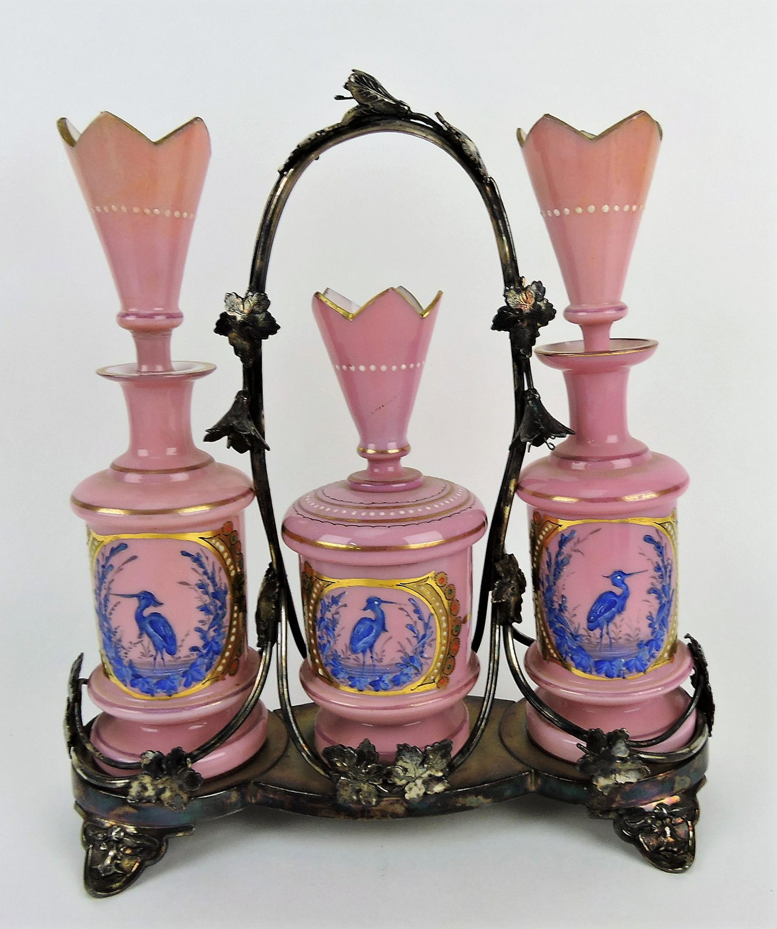 Victorian dresser set with pink glass: pair of cologne bottles and powder jar with stork in marsh decor in silver plate frame (repair to bottle stoppers) 12 1/2"h, 11 1/2"w
