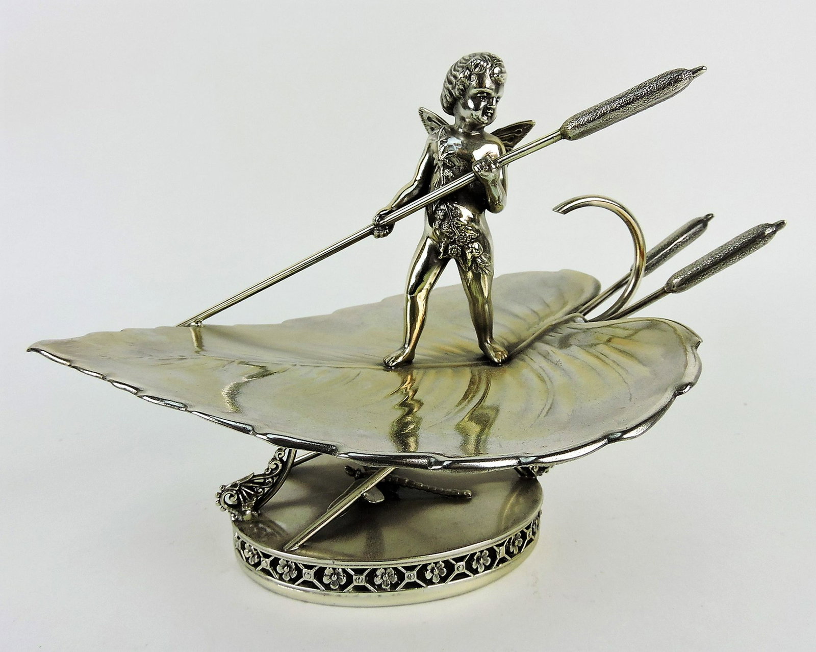 Middletown silver plate server in the: form of a leaf with cherub and cattails, dragonfly on base, 9 1/2"w, 6 1/2"h