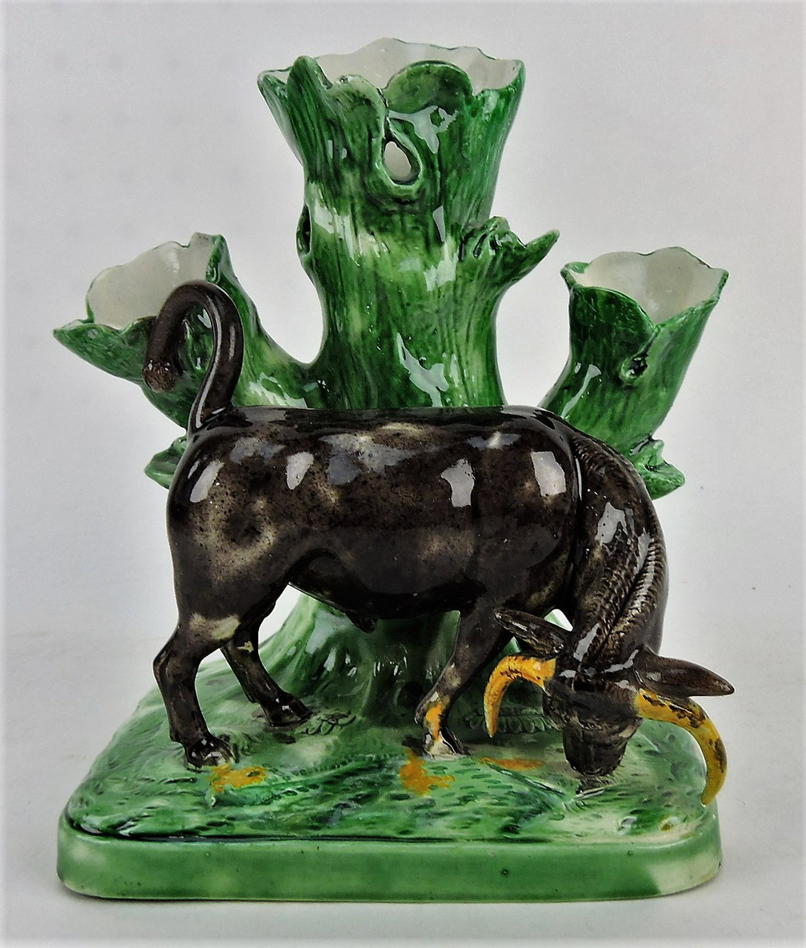 Staffordshire raging bull spill vase,: professional repair to horns, tail, and vase