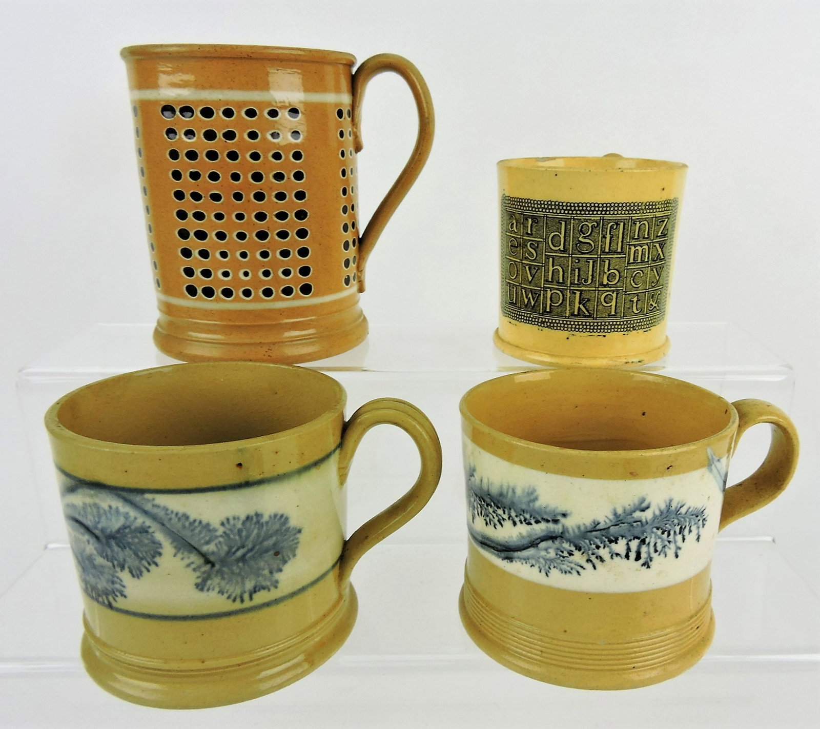 Mochaware lot of 4 mugs - 4 1/2": engine turned pattern of white ringed black dots, 3" ABC mug (rim nick), 2 - 3 1/4" mugs with blue seaweed