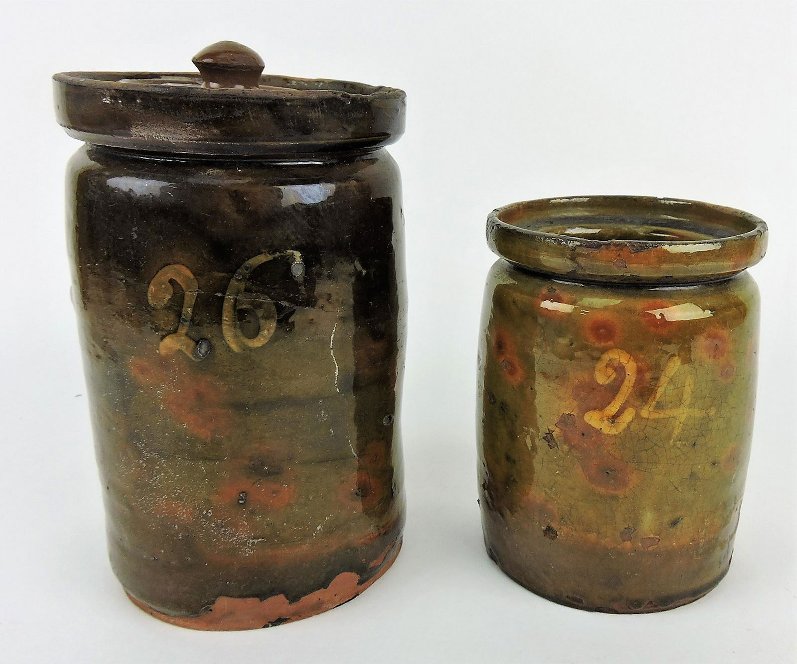 Early redware lot of 2 jars; 8" with: lid (nicks to lid) and 6"