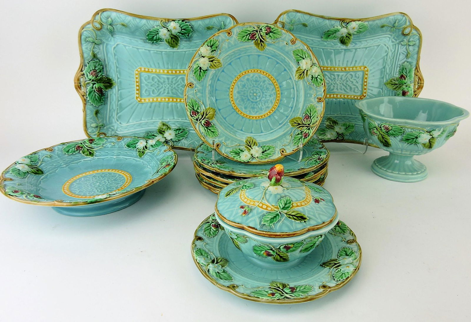 Sarreguemines majolica turquoise: strawberry 11 piece dessert set, 2 - 12 1/2" platters, 9 1/2" low compote, 6 - 8" plates, 6 1/2" compote, and covered butter dish (chip to butter dish lid rim)