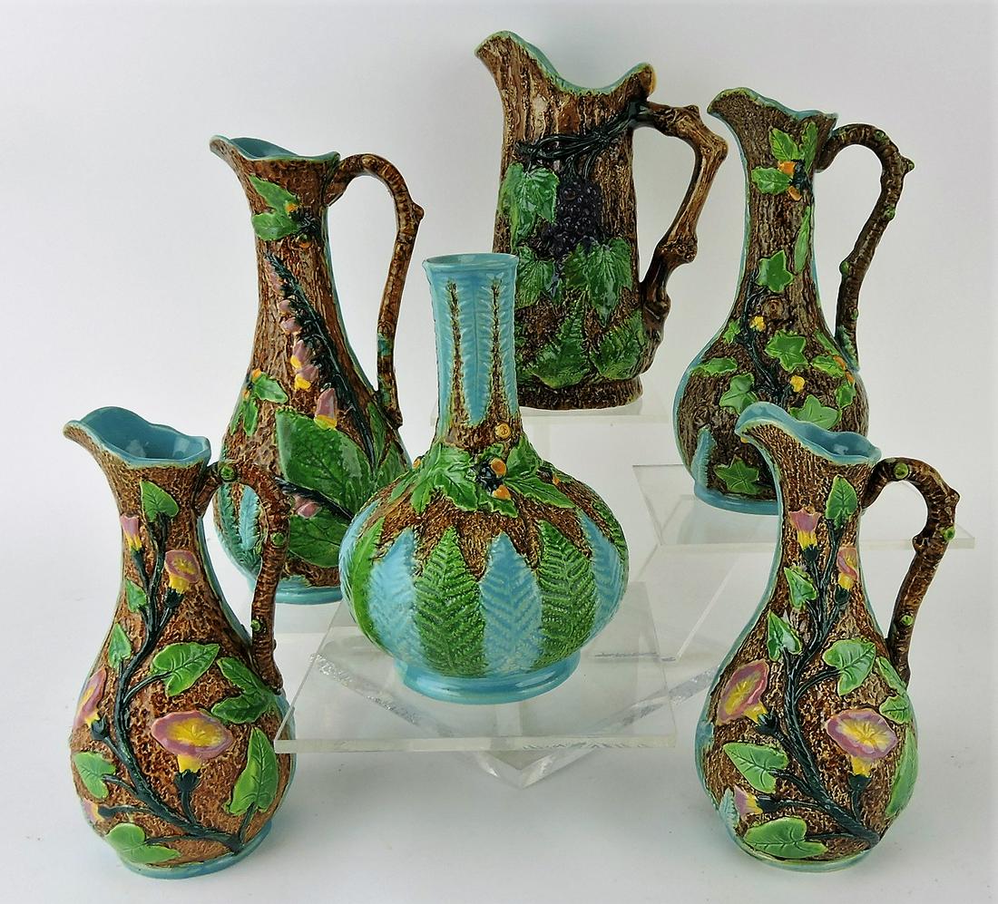 Brownfield majolica lot of 6 items;: 5 ewers and one vase, 6" to 8 1/2", each with different motif - grapes, ivy, oak leaves, acorns, morning glory