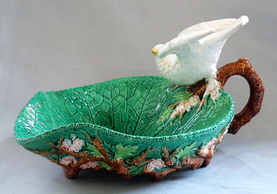George Jones majolica server in: form of large leaf with dove handle, professional repair to dove's wing, 10"l