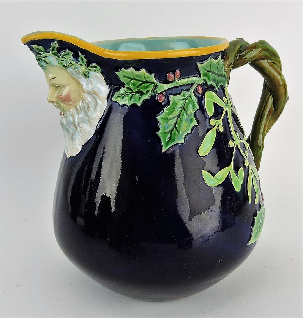 George Jones majolica cobalt: pitcher with Santa spout, holly, and berries, 6 1/2"; professional repair to handle