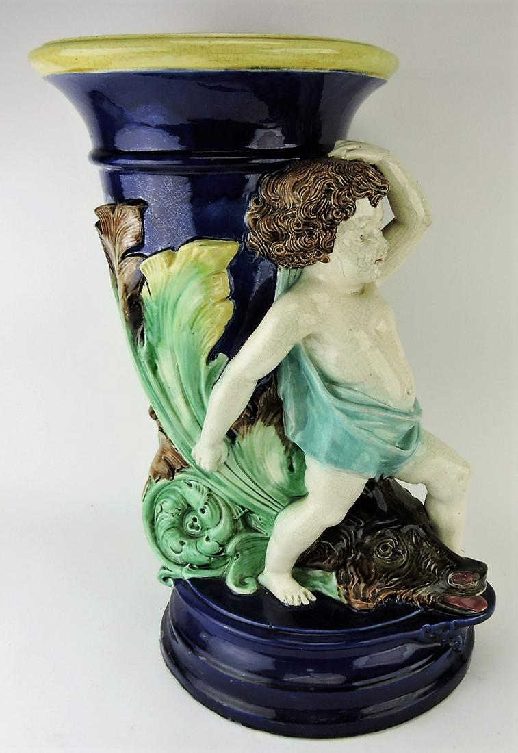 Majolica cobalt umbrella stand with: cherub atop mythological ram's head, professional hairline repair, 22", attributed to Forester
