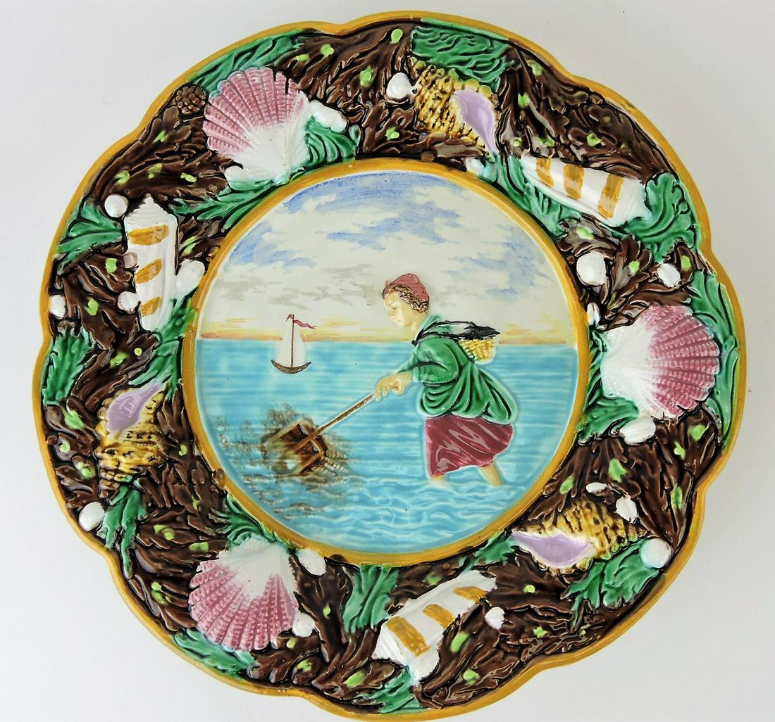 George Jones majolica "Shrimping": plate with scene of girl gathering shrimp, shells and seaweed border, 9 1/4"