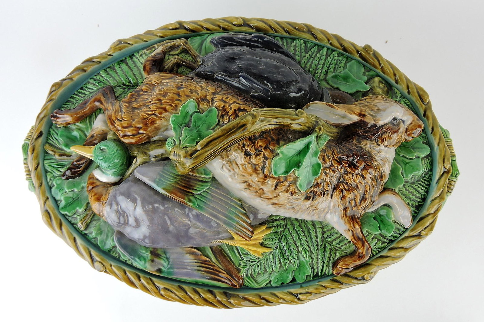 Minton majolica rare large size: game dish with rabbit, duck, and quail on cover and wicker base, professional hairline and handle repair, 16"w, 9"h