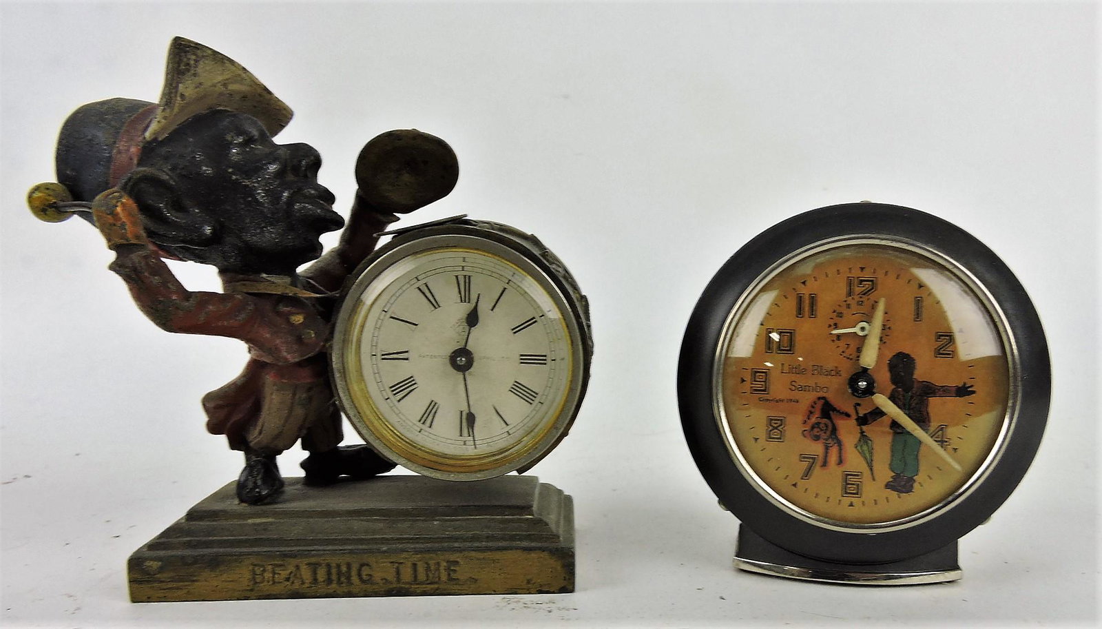 Little Black Sambo alarm clock, 3 3/4",: and Ansonia Black American figural clock with man playing drum and cymbals, 5", both work