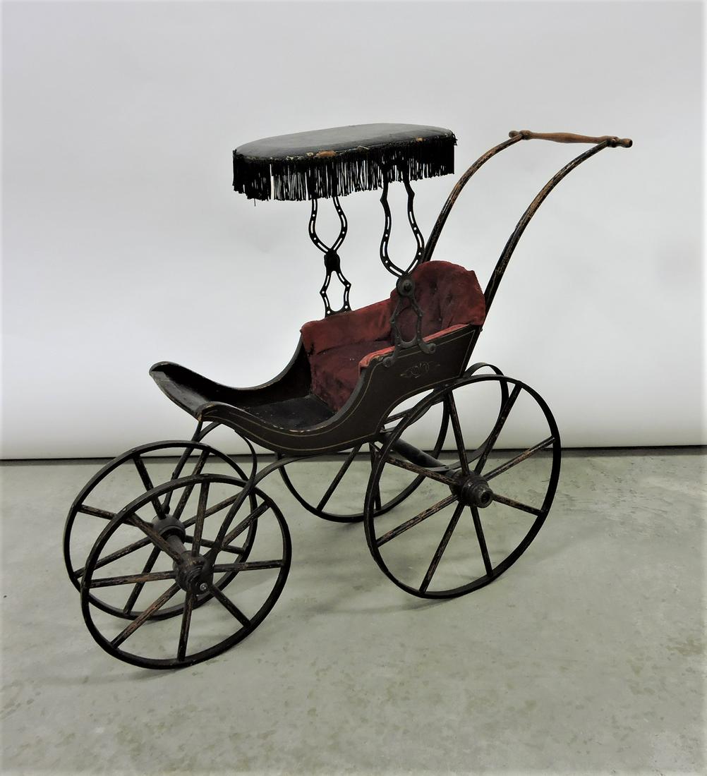 Antique wood and leather doll stroller: .